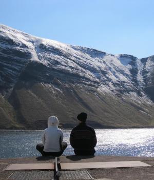 Two friends look over the water
