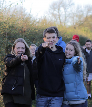 Young people pointing at camera